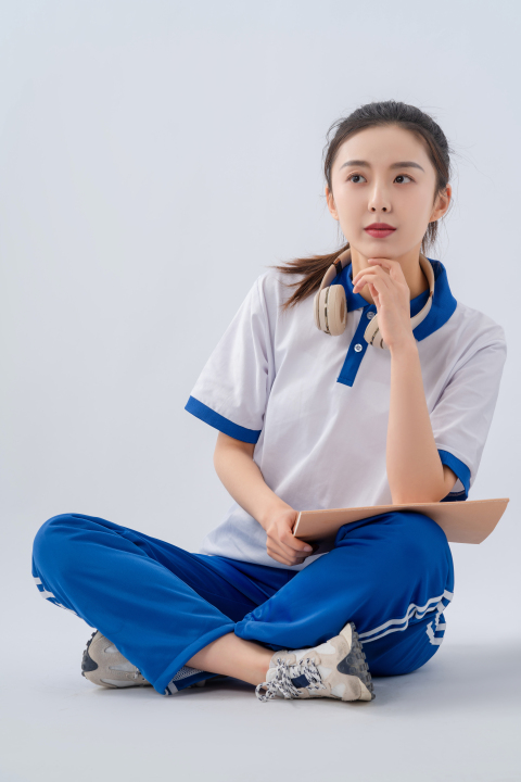 坐地上认真思考的女高中生实拍图版权图片下载