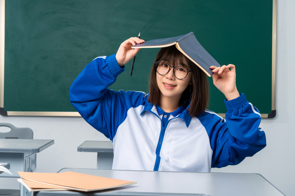 拿着书本不认真读书的女同学高清图版权图片下载