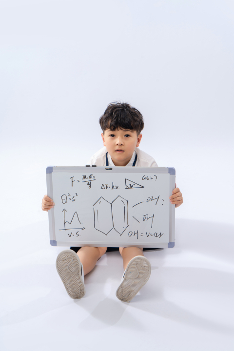 坐在地上举着写满字的白板高清图版权图片下载